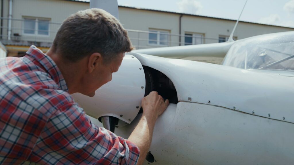 Private airplane inspection aviation engineer close up. Pilot checking aircraft.